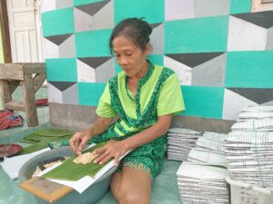 Mislia, karyawan Hadiati, sedang membungkus tempe (05/08/2025) (beritaunsoed.com/Muhammad Robin Mubarok N.)